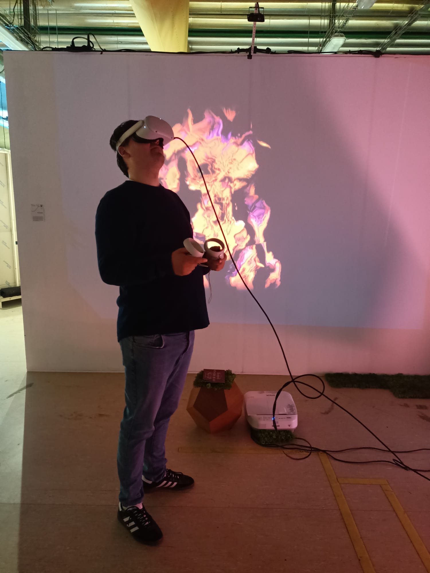 Visitor looking up in VR beneath the flame projection